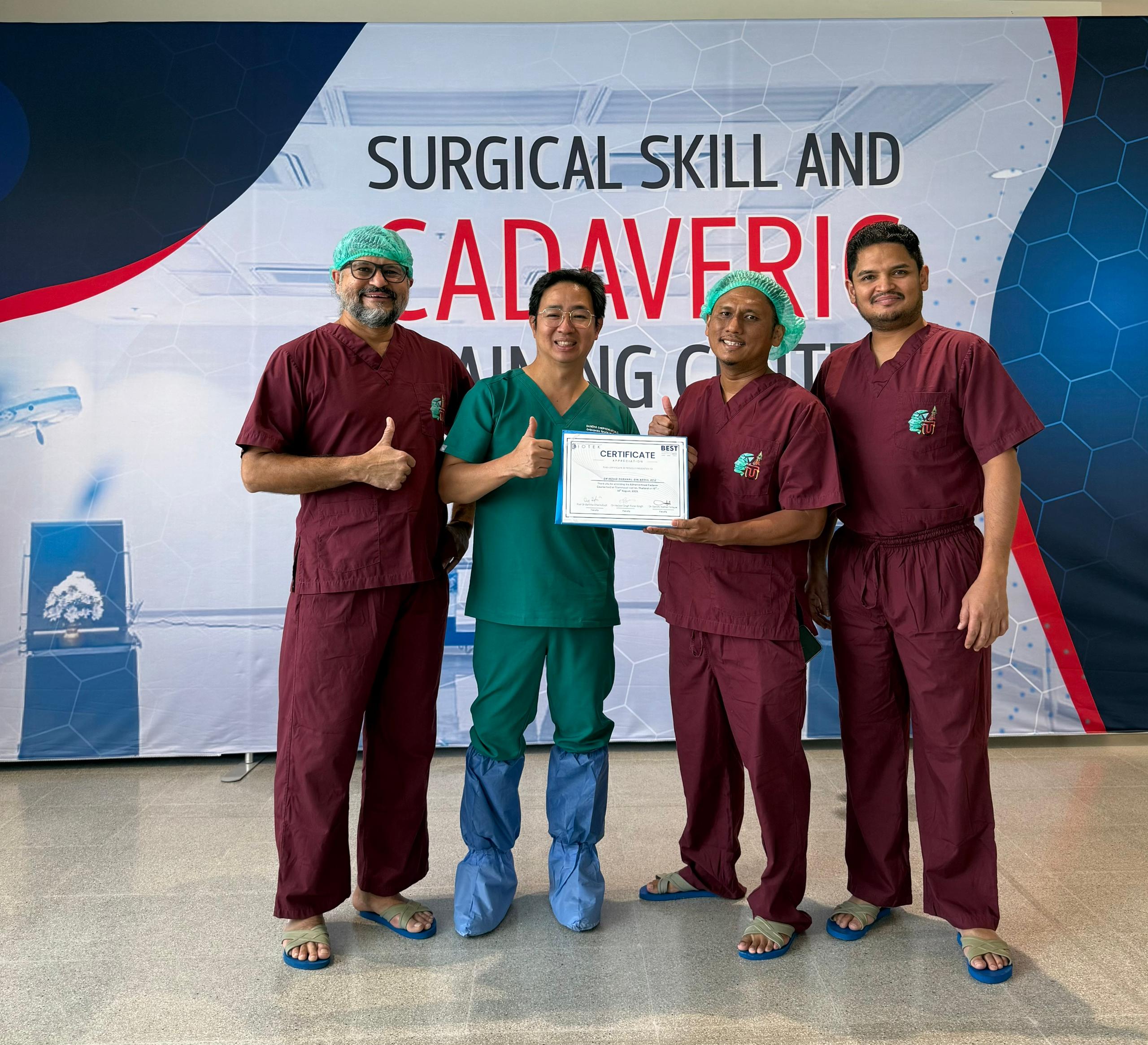 Dr Shaharil receiving a certificate during surgical skills training